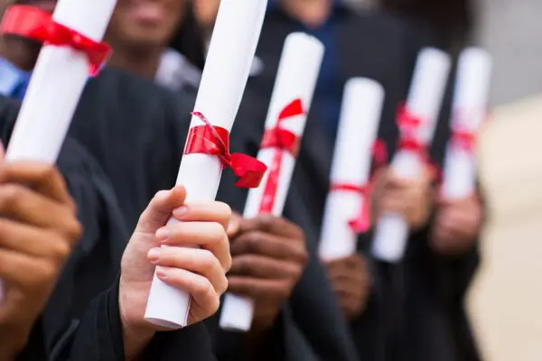 A bunch of students holding their degree